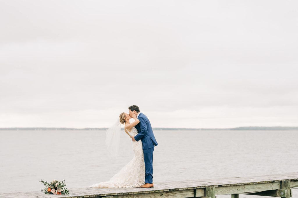 bride & groom kissing on dock in Newport News wedding