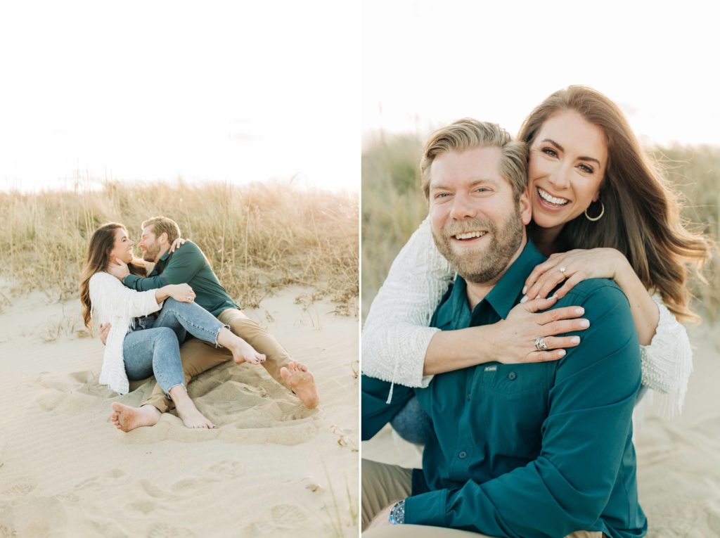 Engaged couple sitting on the beach with women sitting on his lap in the sand. Engaged women hugging her fiancé on the beach at sunset