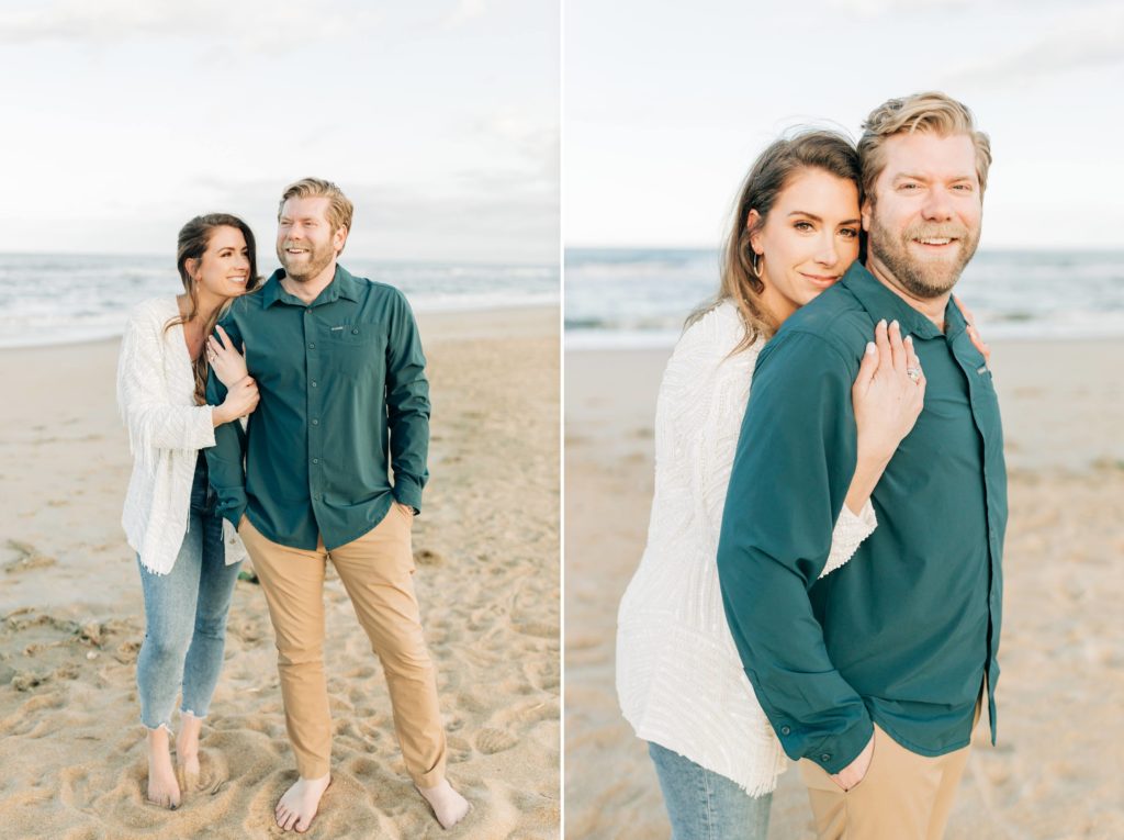 couple standing on the beach looking at each other lovingly. Engaged women hugging her fiancé from behind on the beach while they take photos at the oceanfront for their engagement portraits 