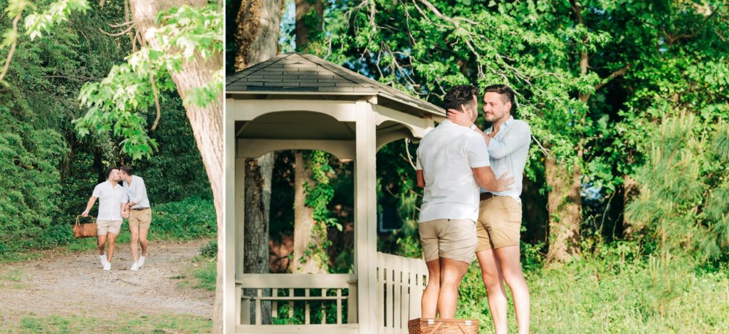 two gay guys walking along the path holding a picnic basket kissing. Two guys looking at each other lovingly 