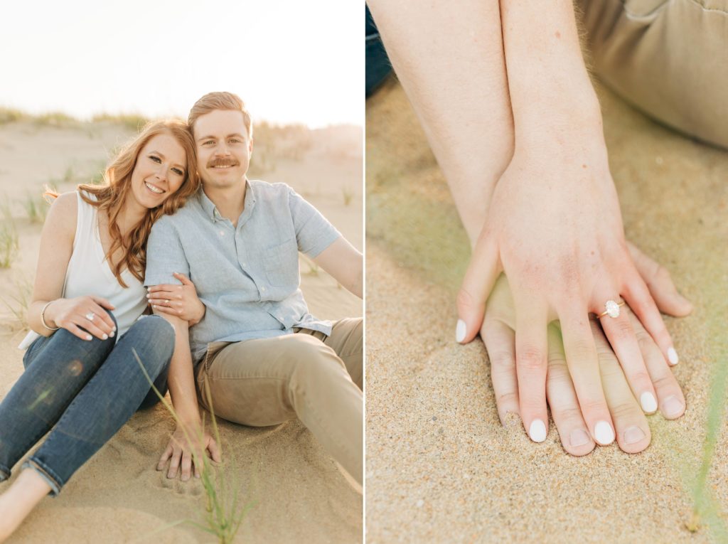 Couple sitting down on the beach looking at the camera while embracing each other during sunset. Photo of a women's hand on top of a man's hand showing off an engagement ring