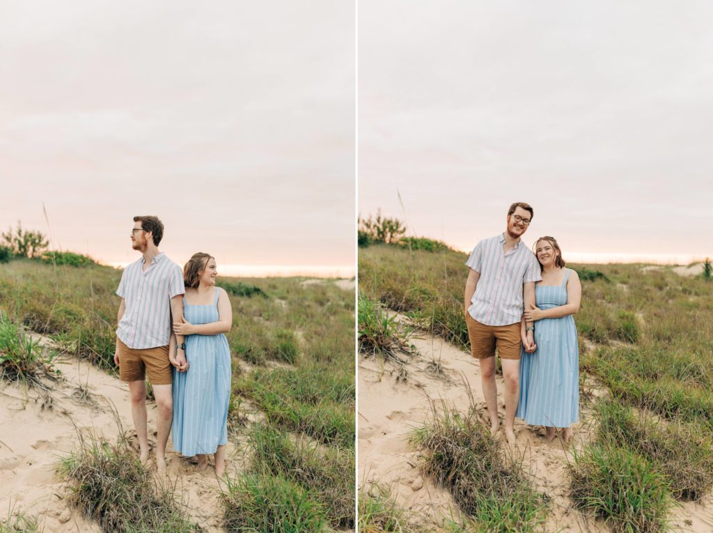 couple standing and looking both ways during their summer beach engagement portrait session in first landing state park 