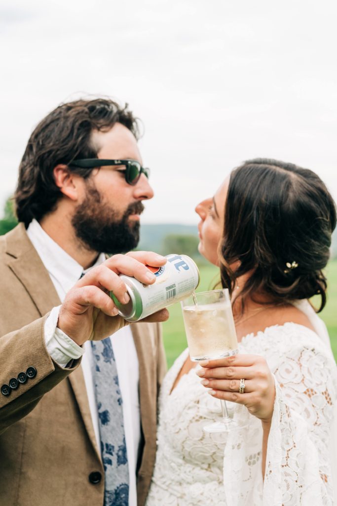 groom pouring beer into brides Champagne