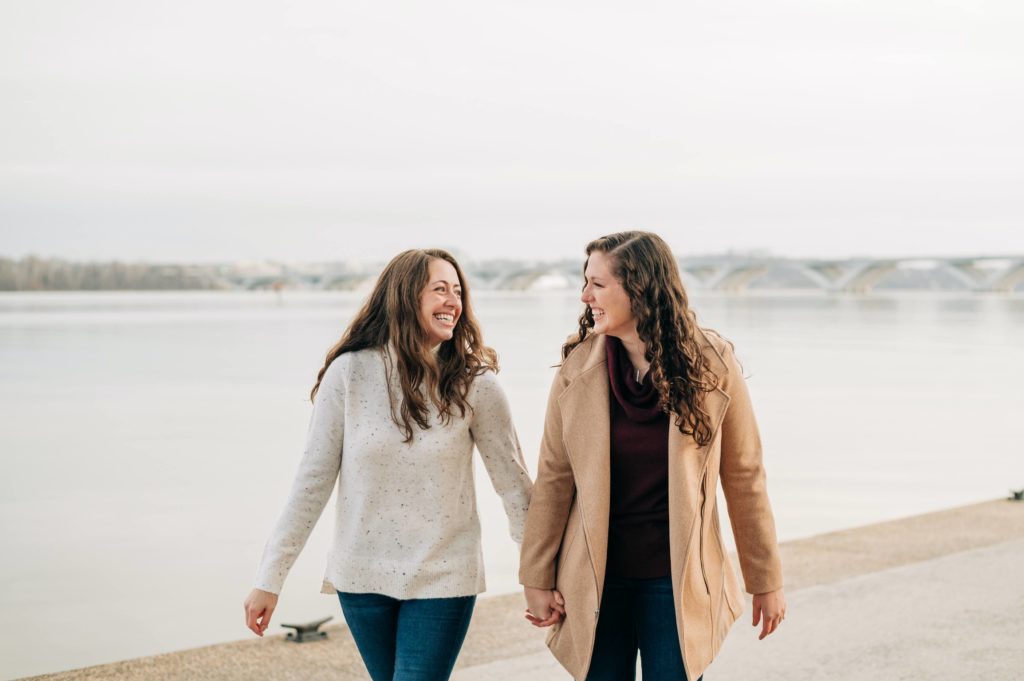 LGBTQ couple smiling along Old Town Alexandria engagement session 