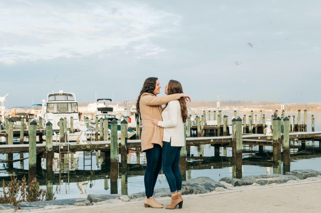 LGBTQ couple by the pier in Old Town Alexandria for their winter engagement session 