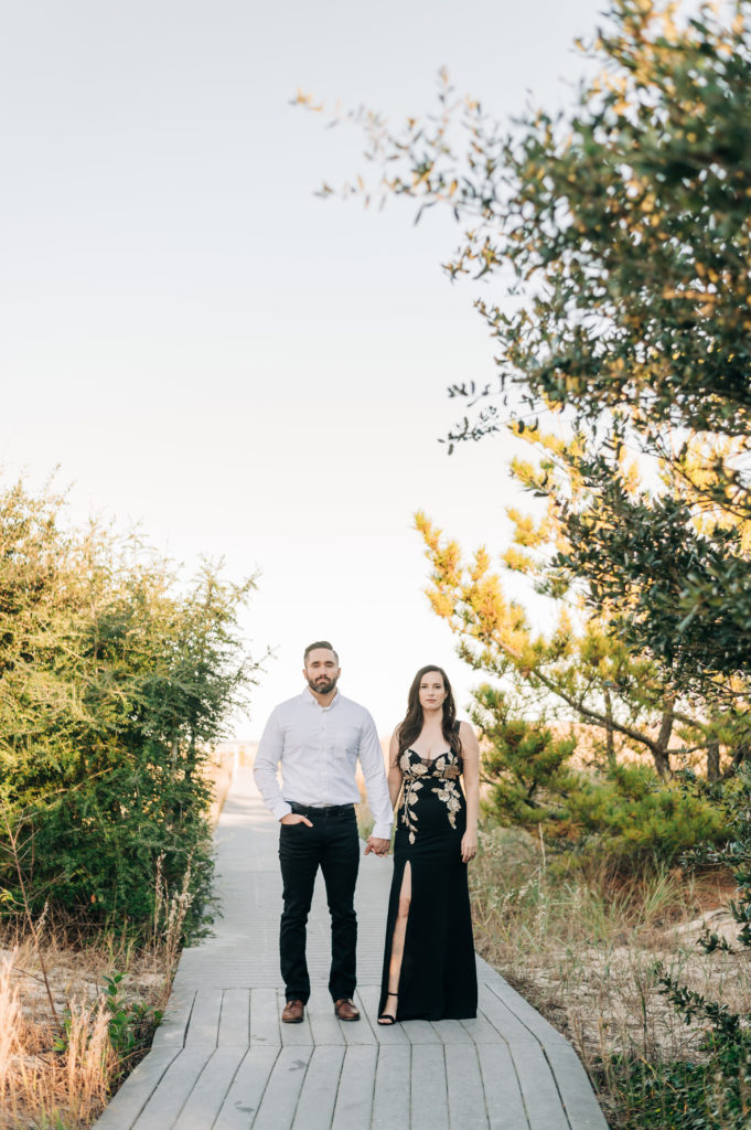 couple standing on boardwalk Virginia Beach Engagement Portraits