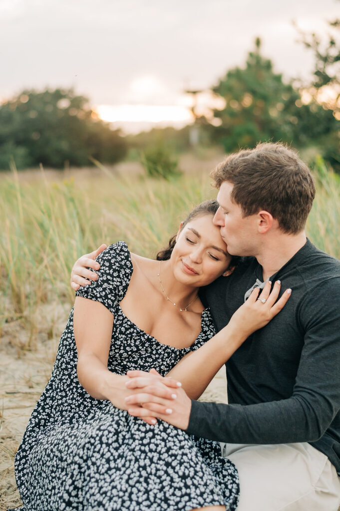 couple snuggling at sunset at Pleasure House Point