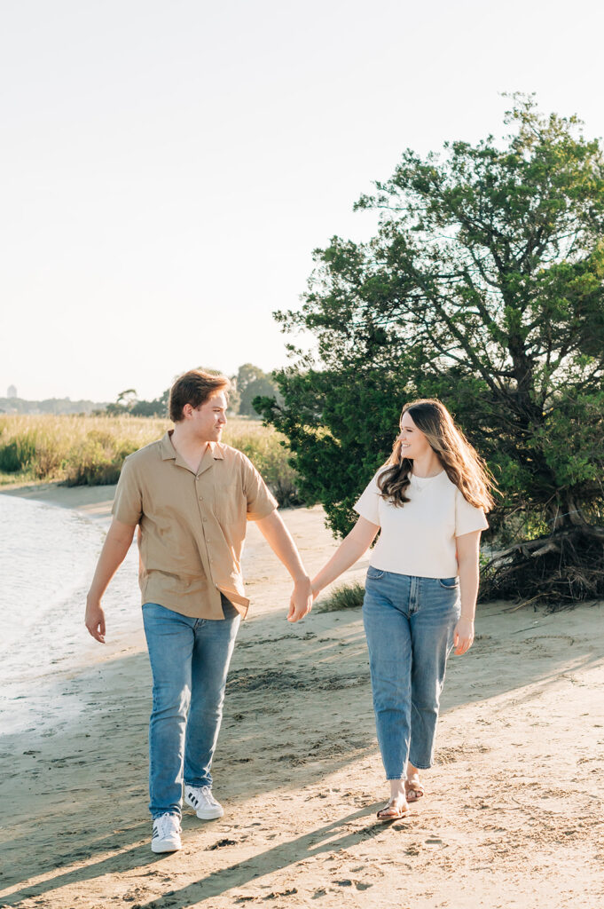 Couple holding hands by water
