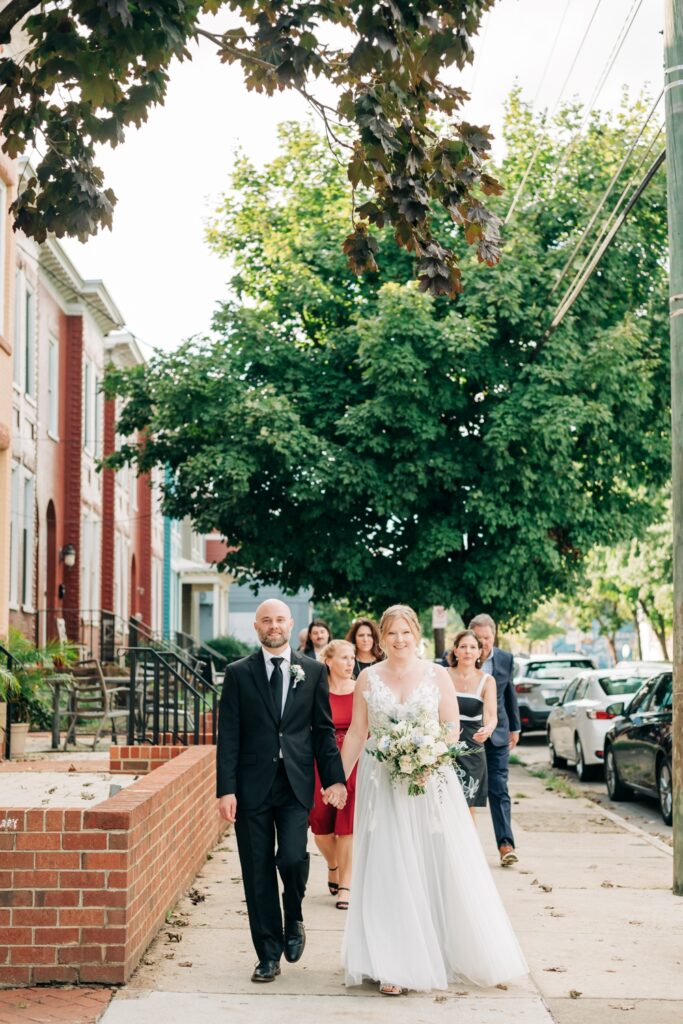 Bride and Groom walking hand in hand to their wedding ceremony in Richmond