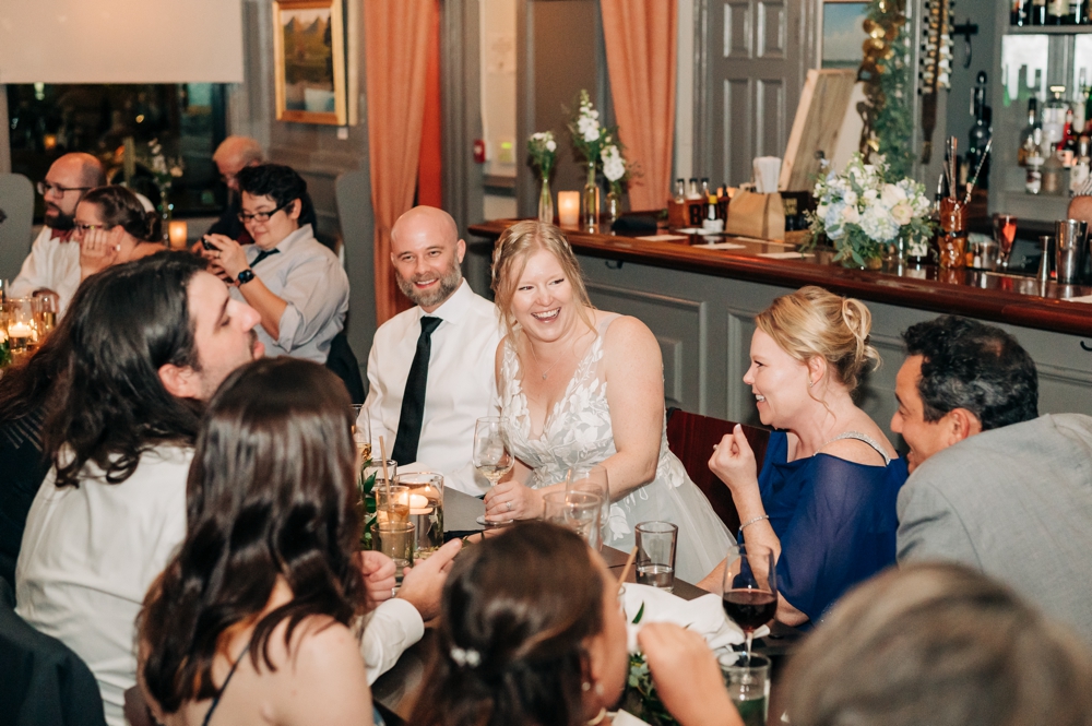 Bride and groom laugh and celebrate with friends