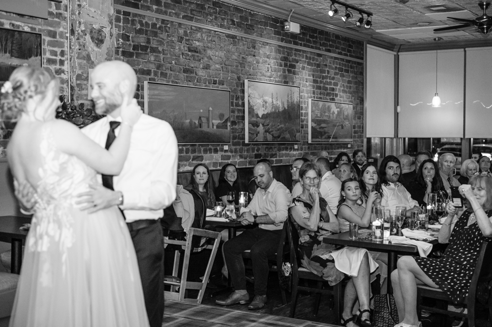 Black and white photo of couple sharing their first dance