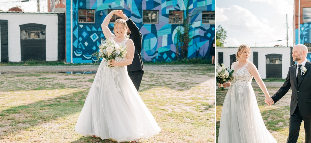 groom twirls bride in front of blue Richmond mural