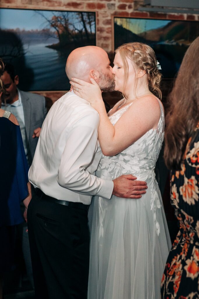 Bride and groom sharing a kiss on the dance floor