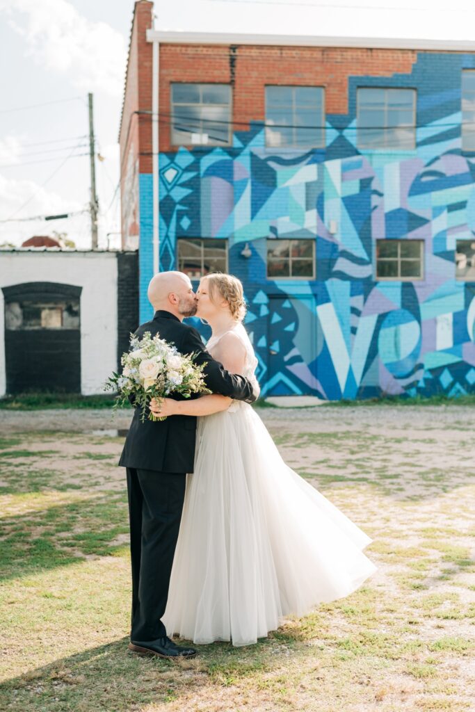 couple kissing after just getting married in the fan district