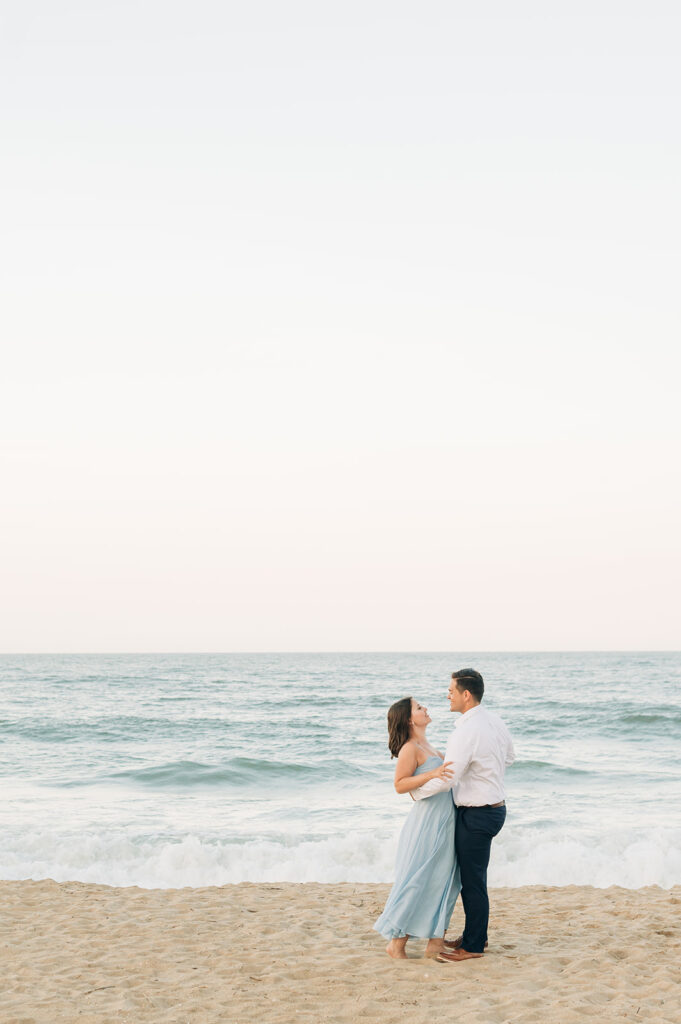 Couple hugging by the ocean in Virginia Beach