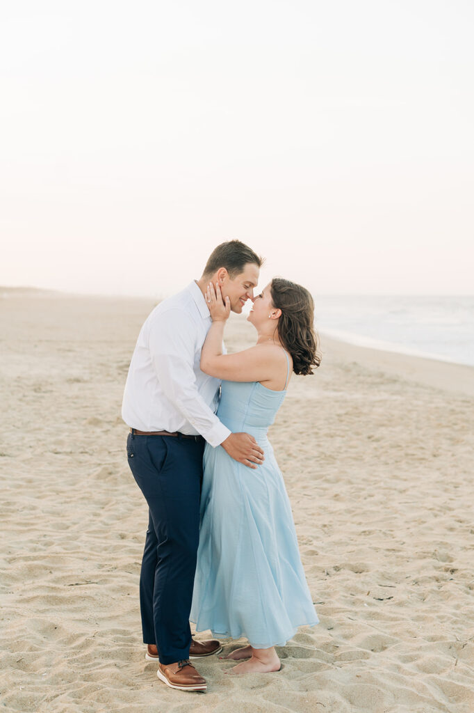 Couple brushing noses on the beach in Virginia Beach