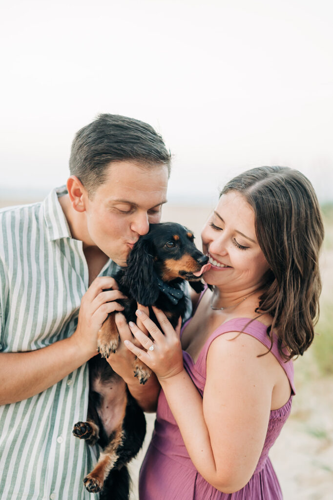 Couple hugging their Weiner dog in Virginia Beach