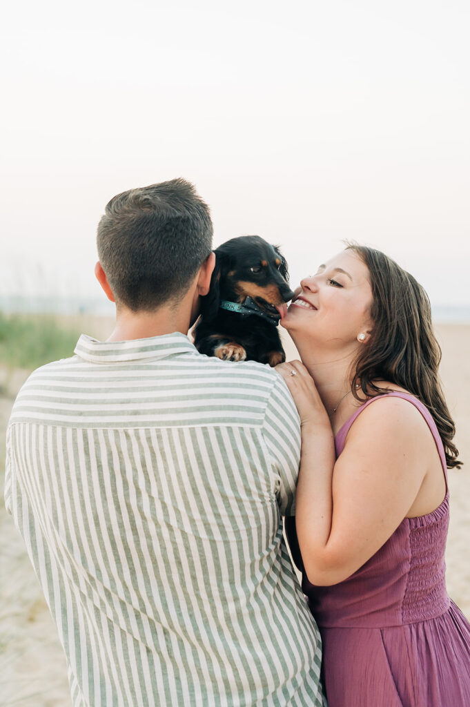 Couple kissing their Weiner dog in Virginia Beach