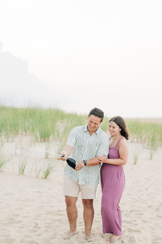 Couple popping champagne on the beach in Virginia Beach