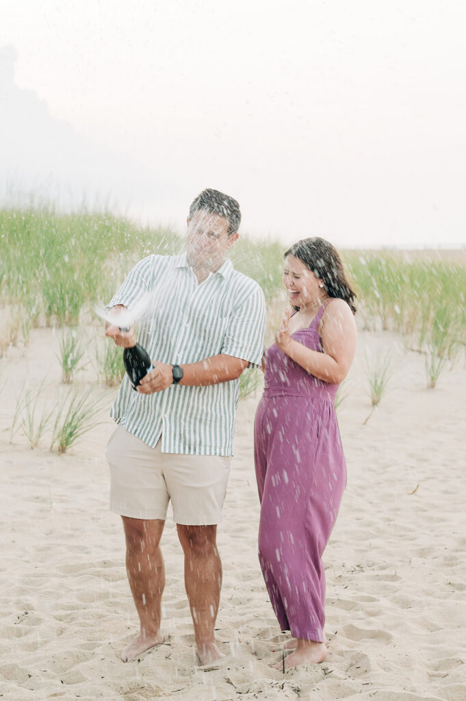 Couple shaking champagne on the beach in Virginia Beach