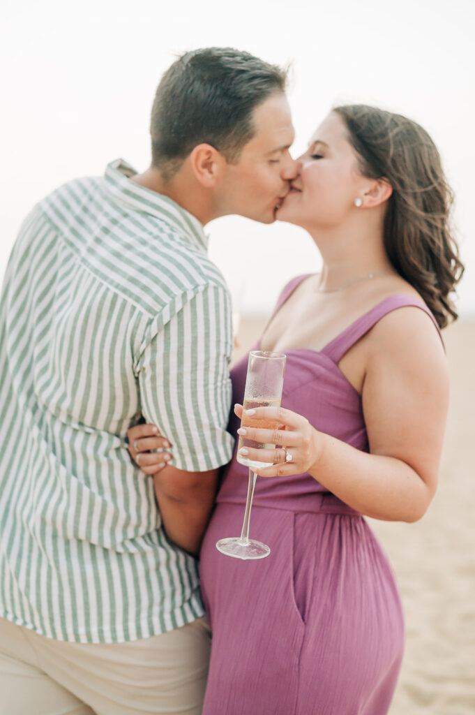 Couple kissing and drinking champagne in Virginia Beach