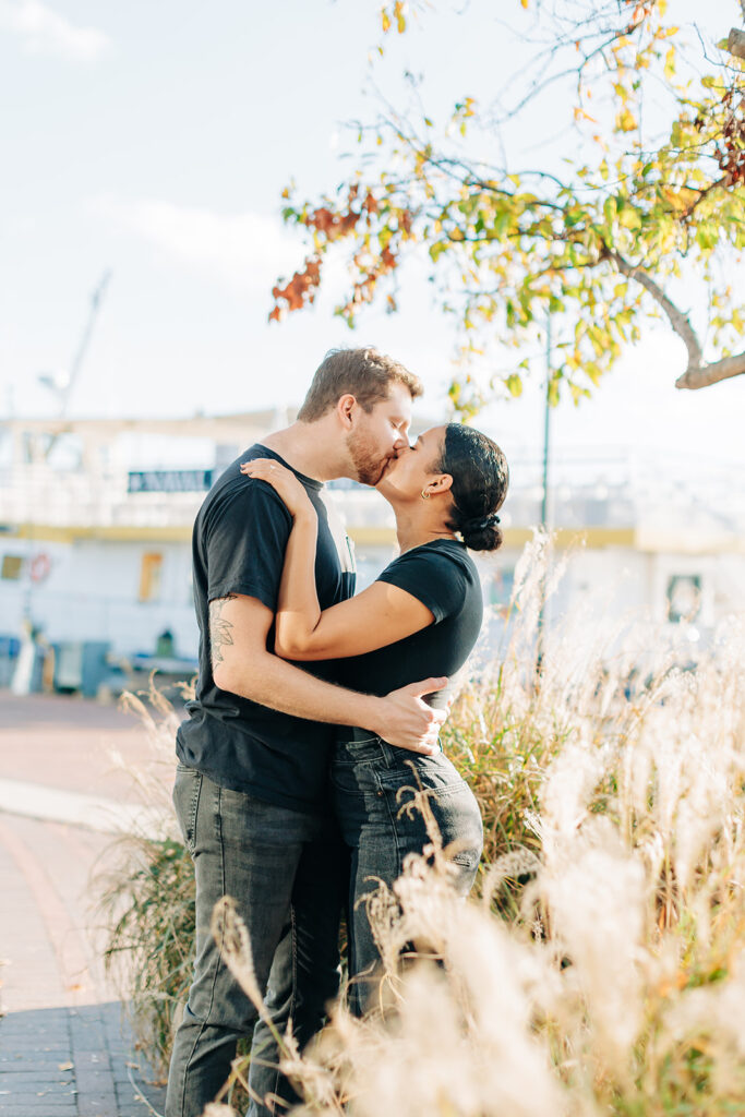 Couple kissing in Norfolk waterside district
