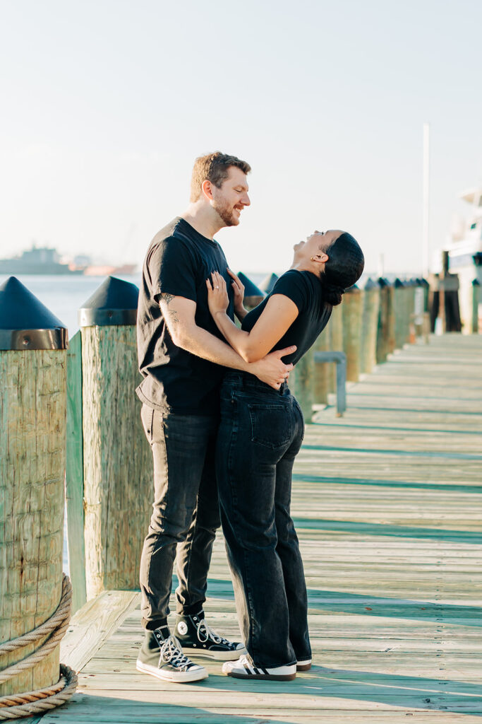 Couple laughing in Norfolk waterside 