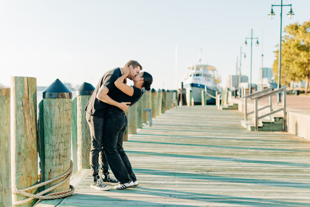 Couple kissing by ships in Norfolk 