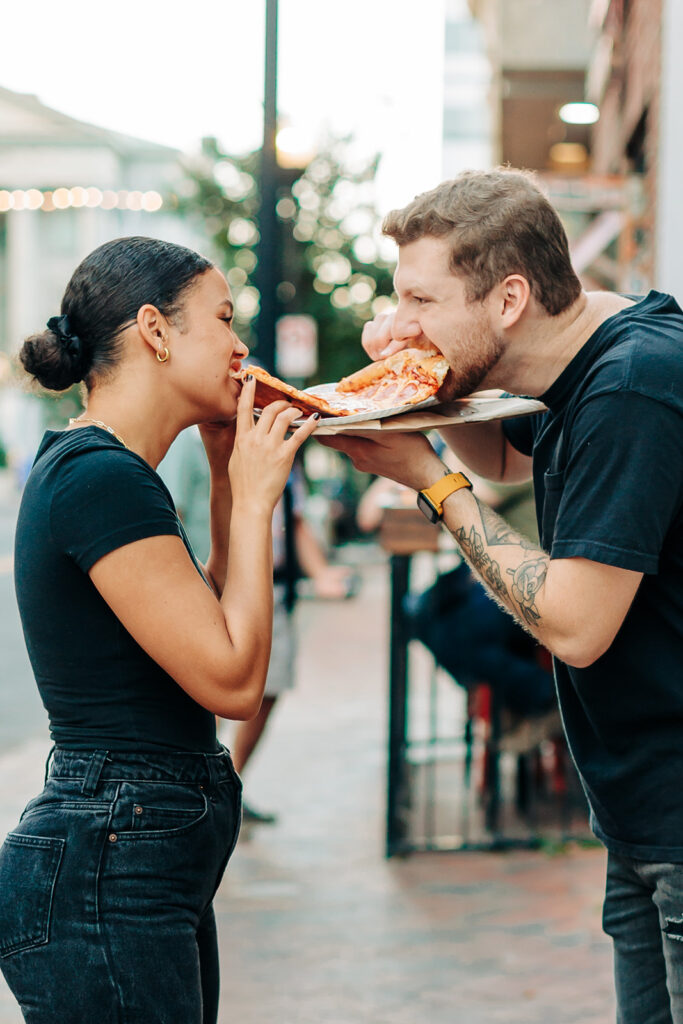 Couple sharing a slice of pizza