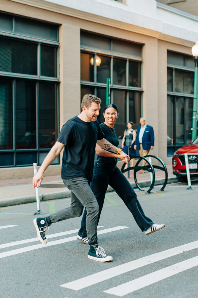 Couple running across the street