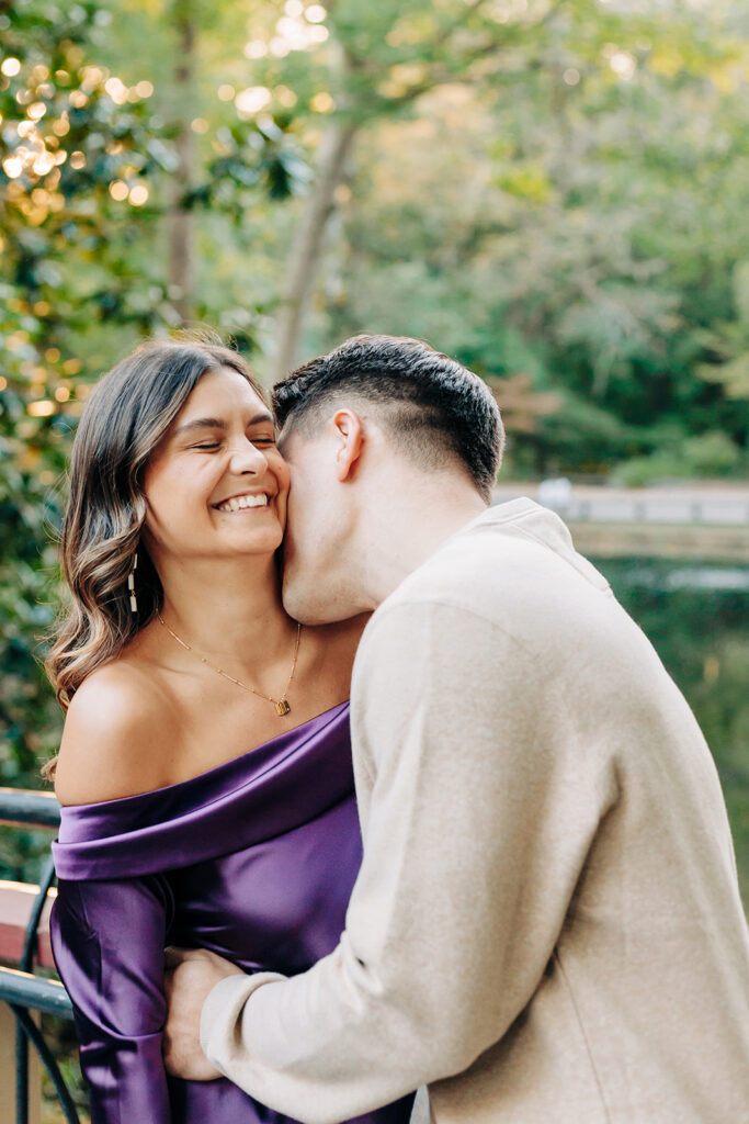 Couple kissing on bridge