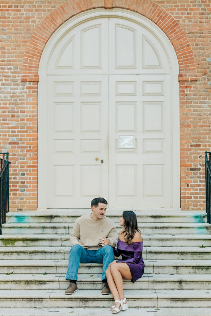 Couple sitting on steps at Wren Building