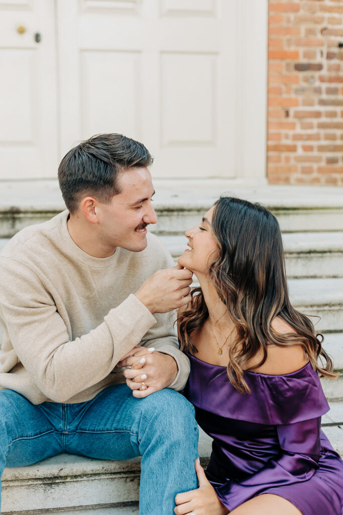 Couple leaning in for a kiss on the steps