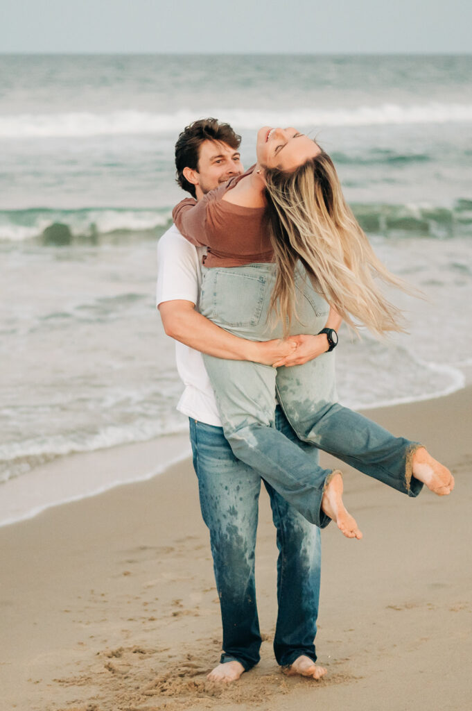 couple jumping for joy on the beach