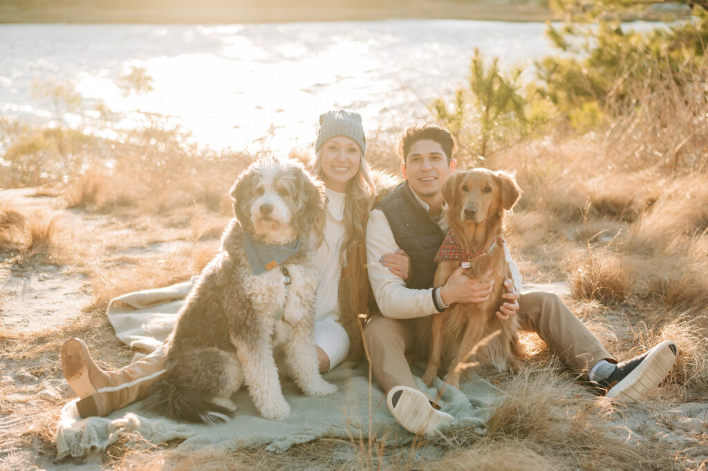 couple smiling with dogs