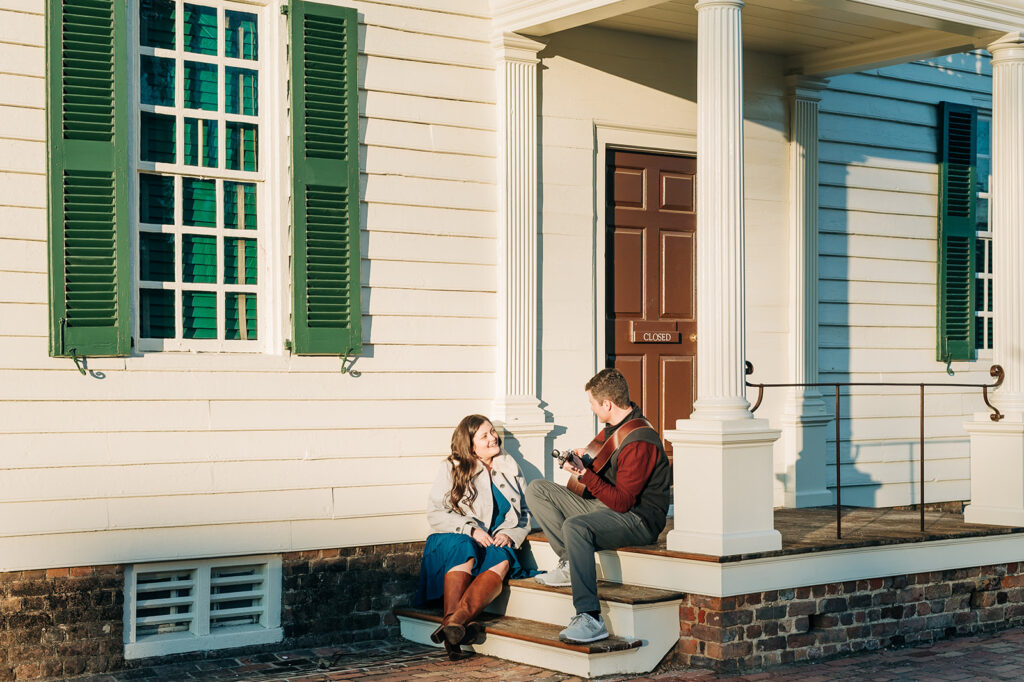 boy playing guitar on steps for girl