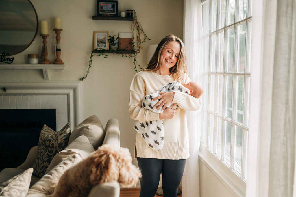 mom looking at dog with baby