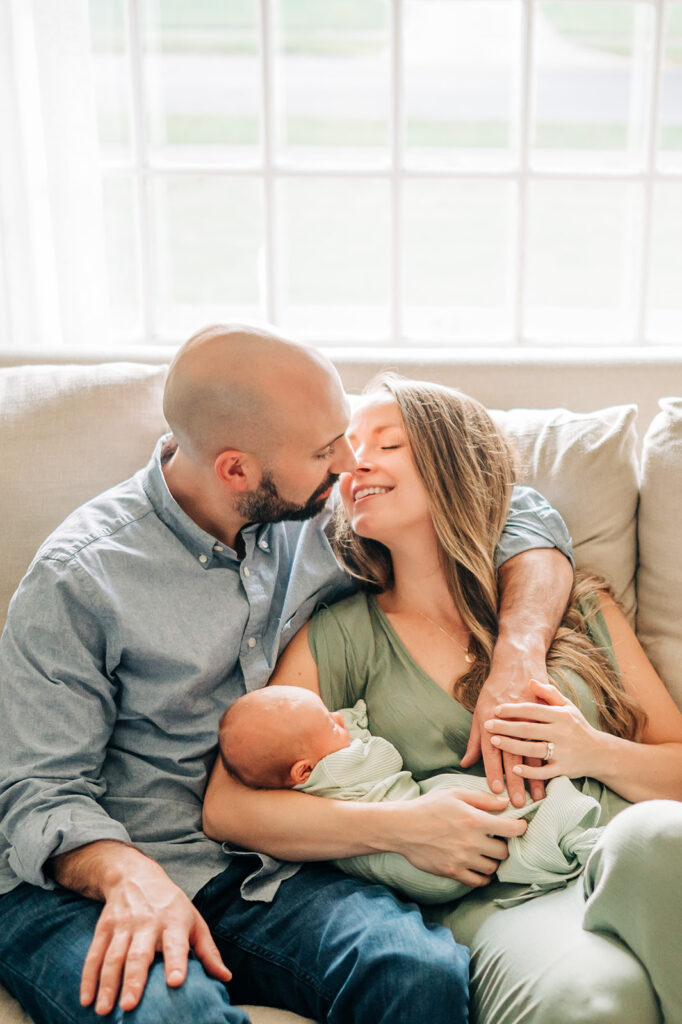 family cuddles on couch