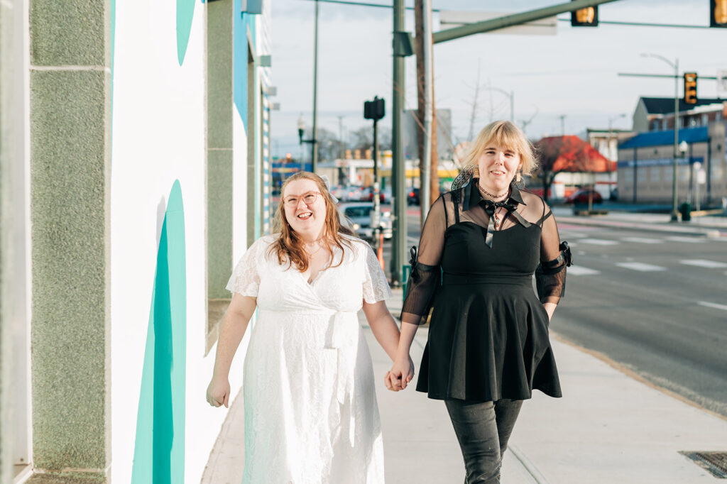 who women laughing and holding hands