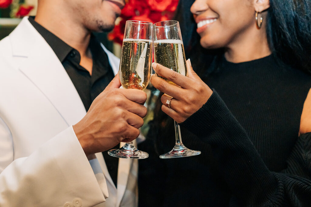 couple clink champagne glasses