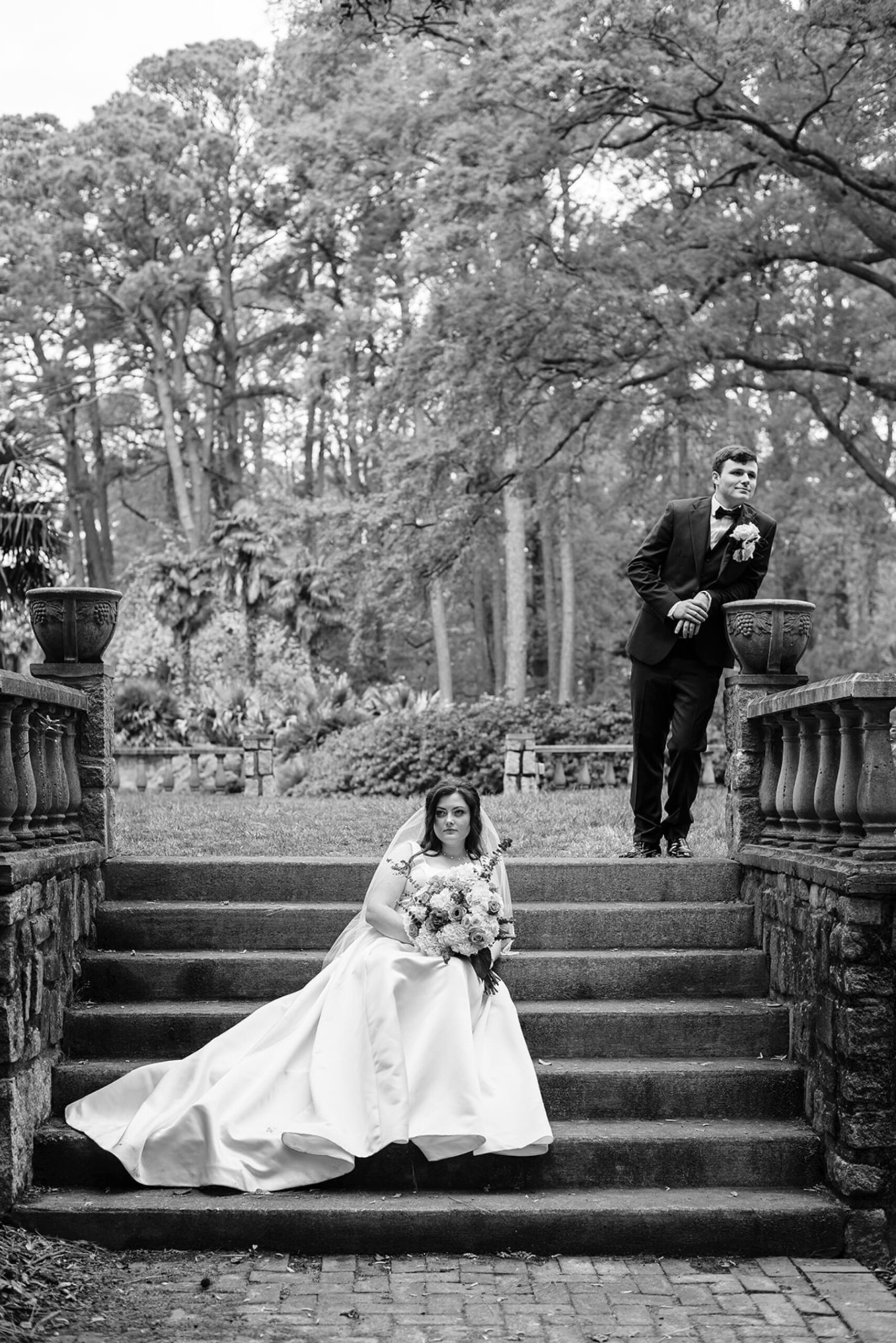 black and white photo of bride and groom on stairs