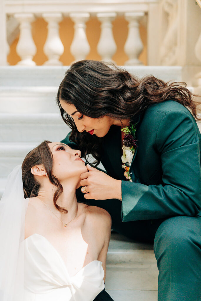 brides pose on stairs
