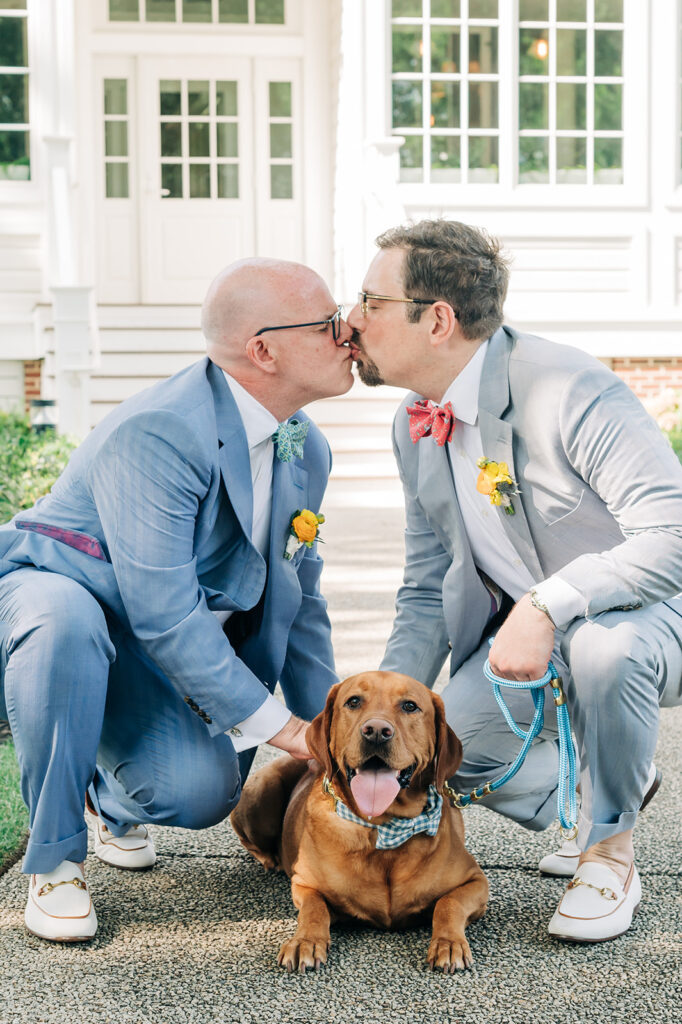 grooms pose with dog