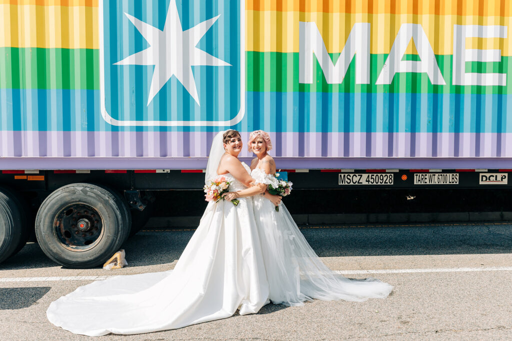 brides pose by truck