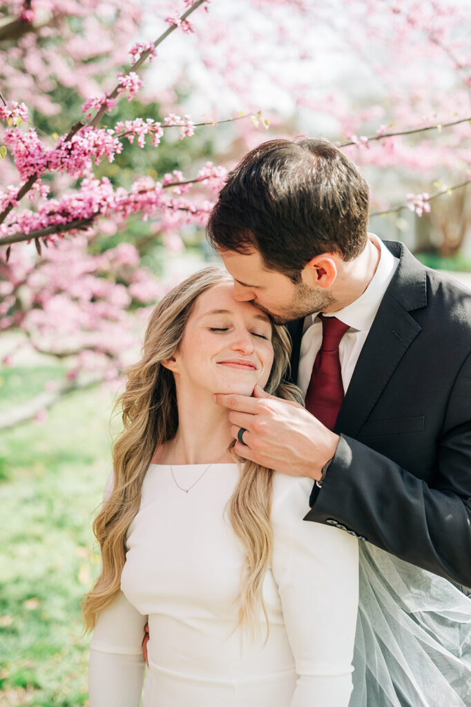 couple poses under tree