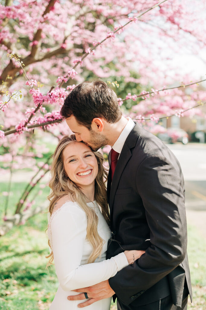 couple smiles under tree
