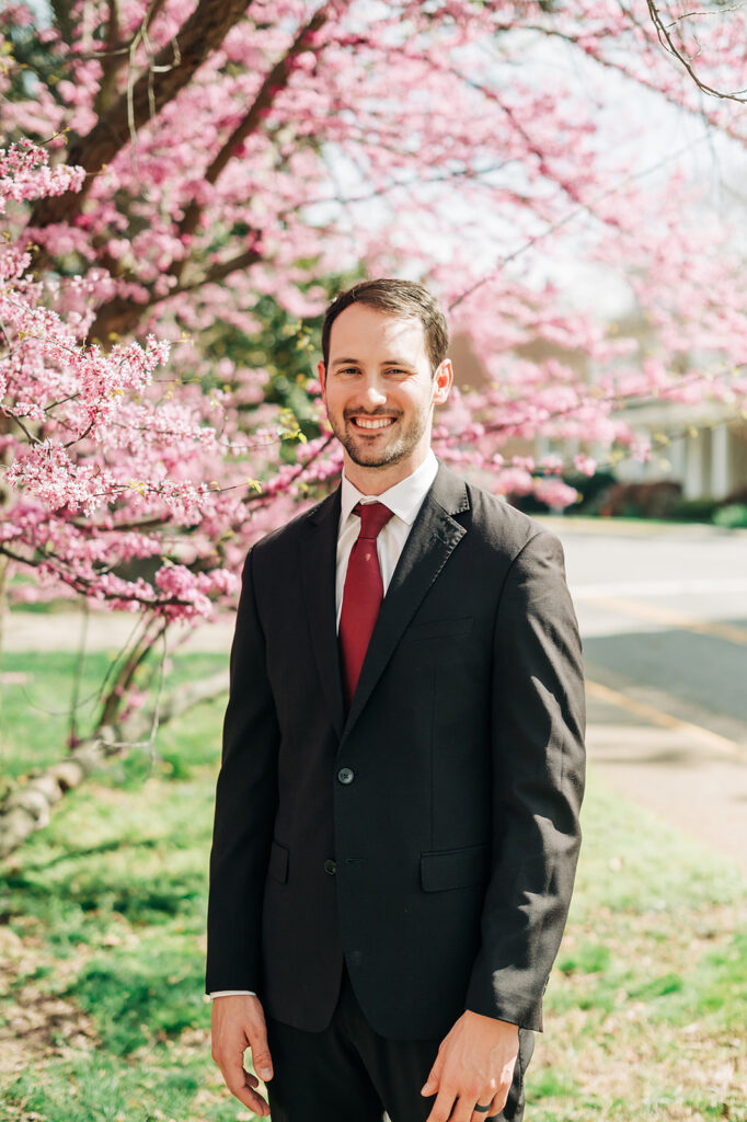 groom standing infant of cherry blossom