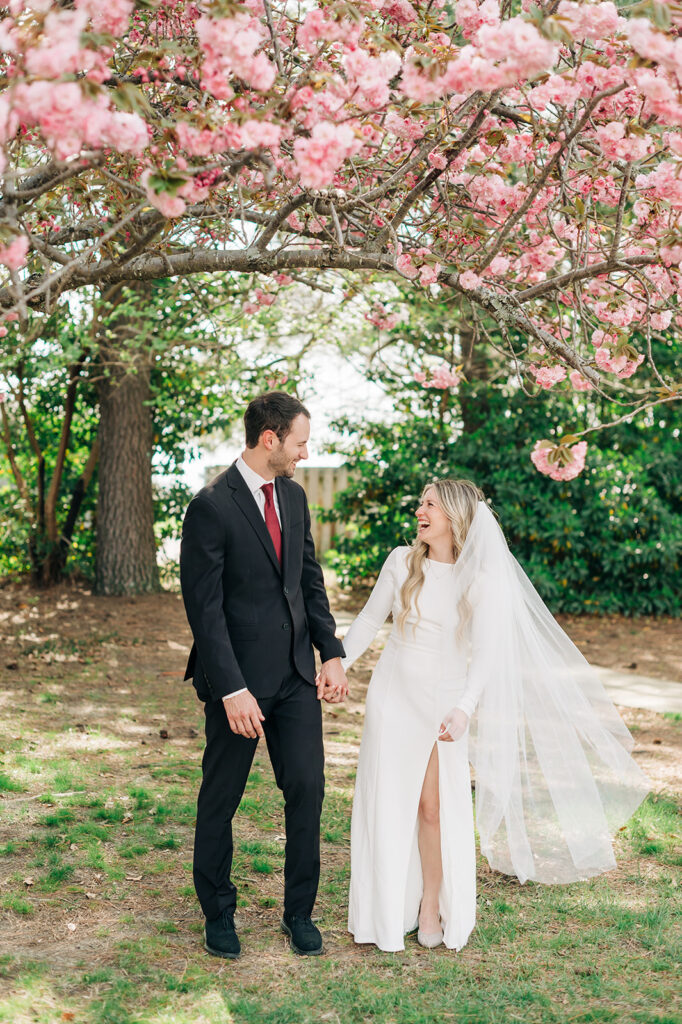 couple laughing under tree