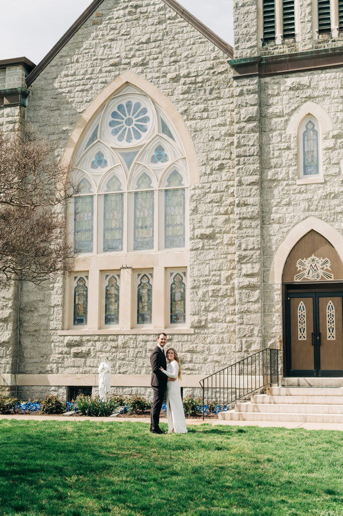 couple hugs infront of church