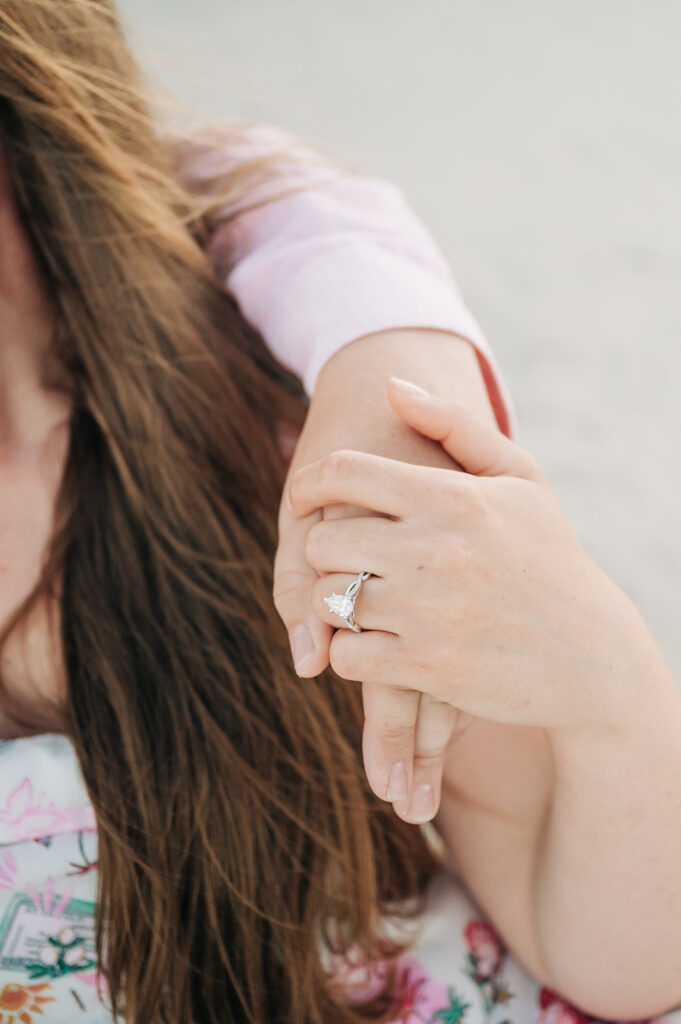 couple holds hands after proposal